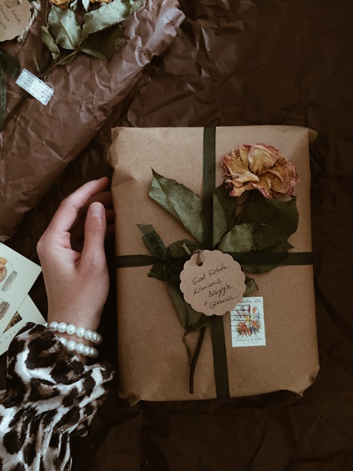 category-02 Handcrafted gift wrapped in brown paper with dried flowers and handwritten label, perfect for special occasions.